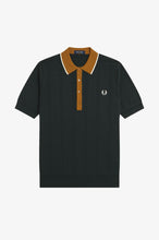 Load image into Gallery viewer, A dark green ribbed short-sleeve polo shirt by Fred Perry, featuring a contrasting mustard yellow collar and placket with white piping and a small embroidered laurel wreath logo on the chest.
